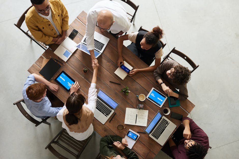 A group of people engaged in a meeting, discussing and strategizing together.