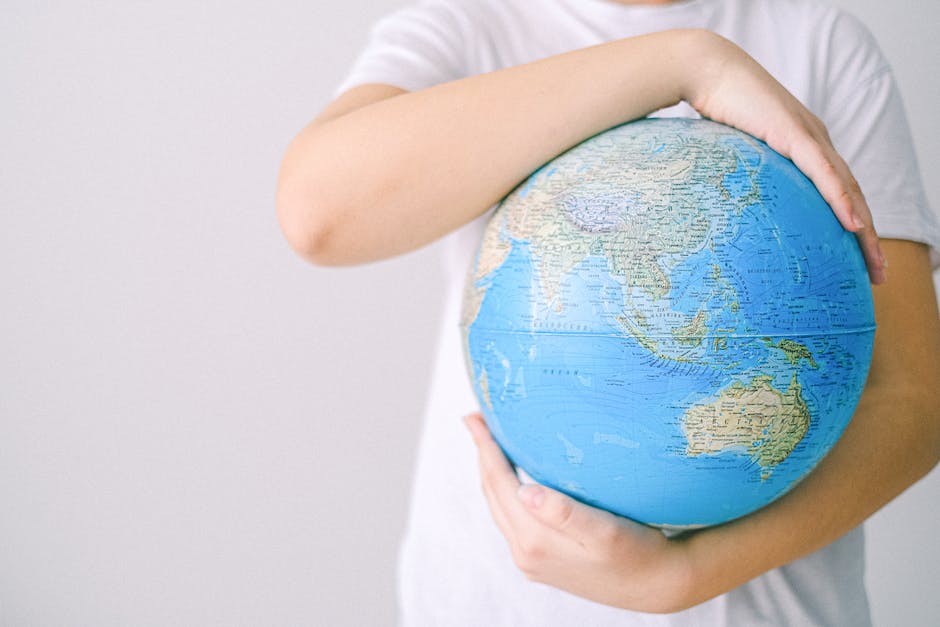 Image of a person holding a globe, symbolizing the global impact of program managers