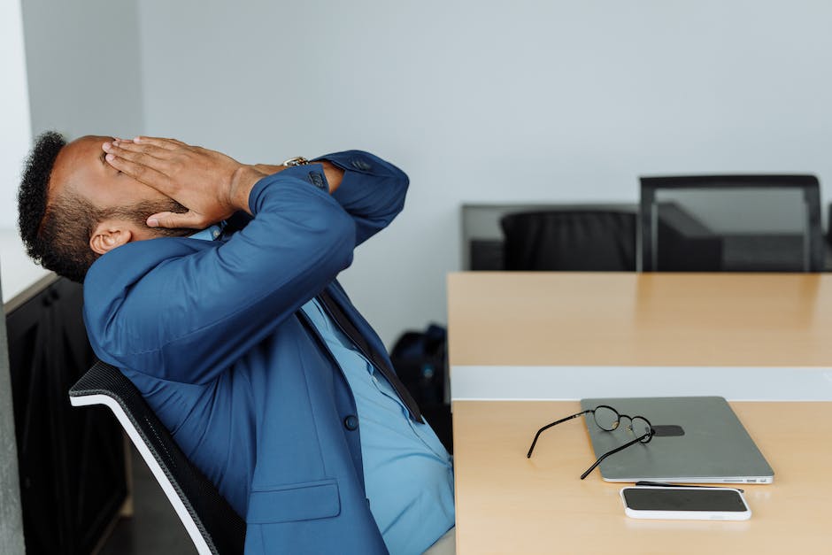 A person sitting at a desk and looking stressed, representing job change stress.