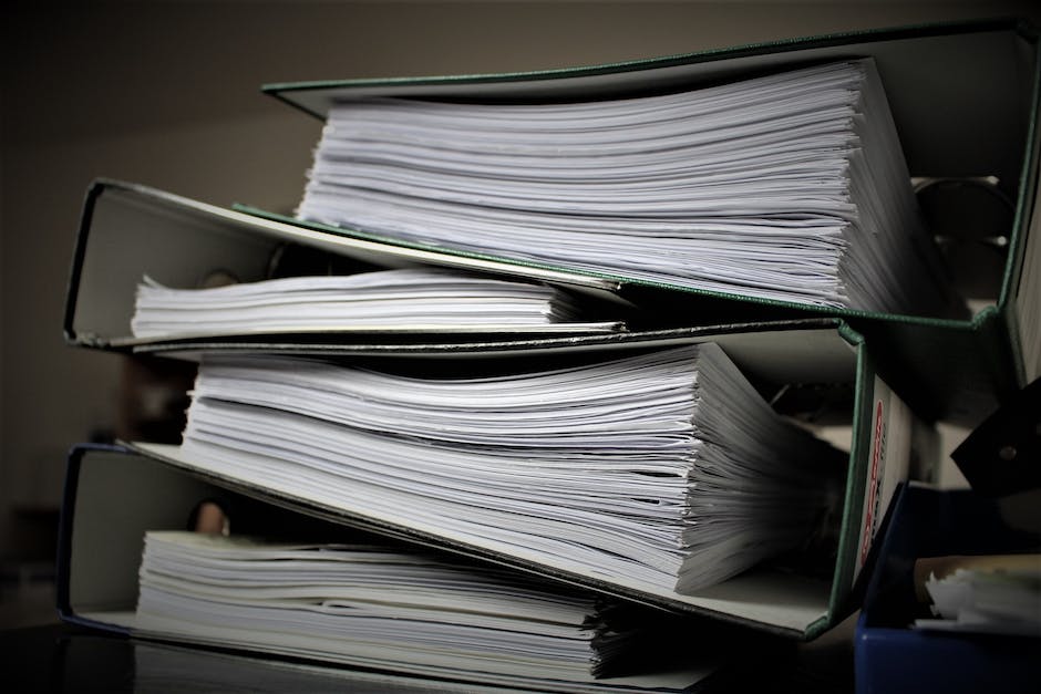 A busy office worker with a stack of papers, symbolizing job change stress.