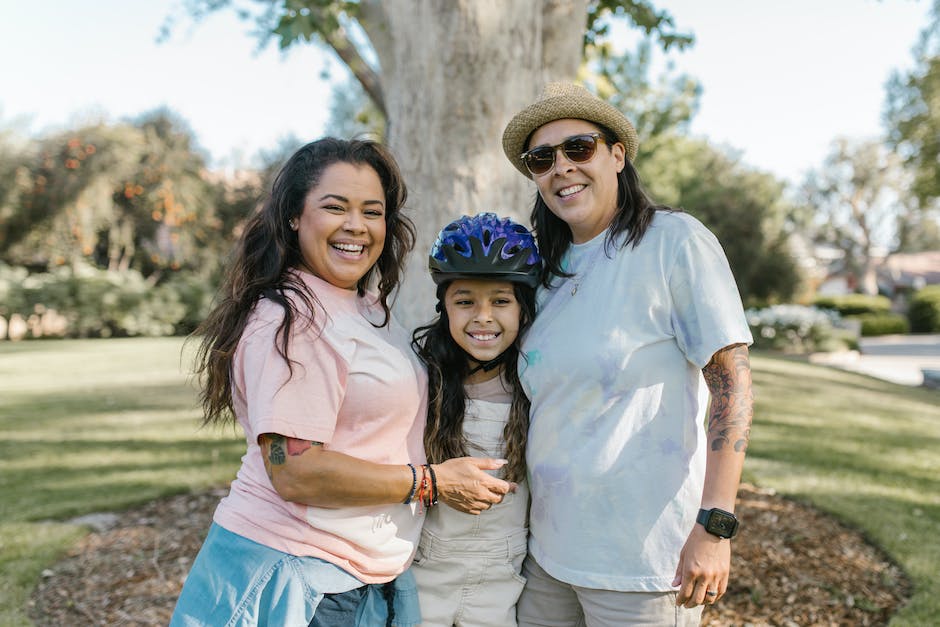 A supportive family standing together and holding hands in unity, symbolizing support for a child affected by a narcissistic spouse.