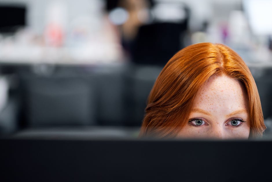 Illustration of a software engineer sitting at a computer, working diligently, surrounded by lines of code and complex technology.