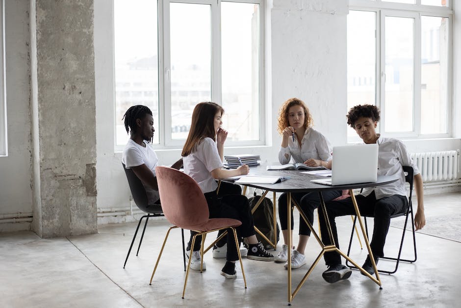 A team of diverse individuals working together in an office, symbolizing motivation and collaboration