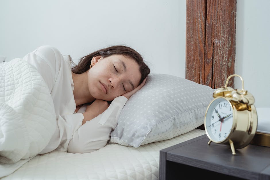 An image depicting a person sleeping peacefully with a smile on their face, illustrating the importance of sleep for overall well-being.