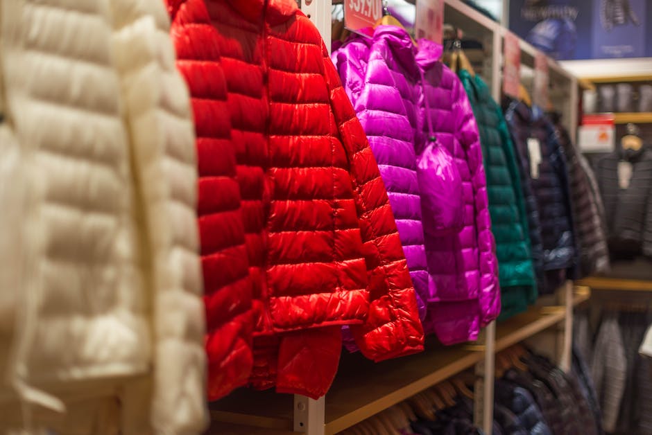 Image of a person properly storing winter clothes in airtight containers, with garments neatly folded and organized, showcasing the importance of preserving winter wear for future seasons.