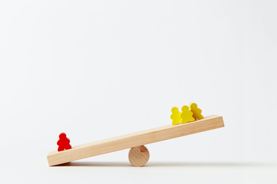 Image describing work-life balance, with a person balancing a briefcase and a personal item on a seesaw